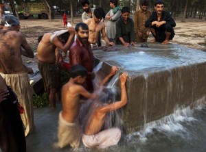 Handling heat, the Pakistani way...Labourers cooling off at a leaky hydrant